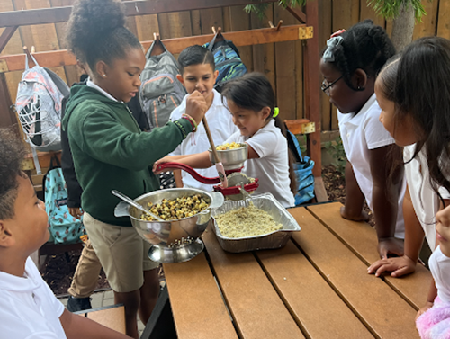 Hispanic Heritage Month - students making a recipe on picnic table